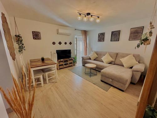 a living room with a couch and a table at Accommodation near the Cathedral LaCuevitadeLeo in Toledo