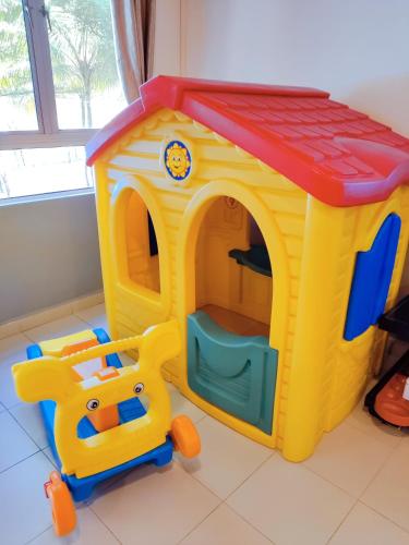 a childs toy dog house with a toy car at Le'Coco Homestay in Tiara Desaru Residence in Desaru