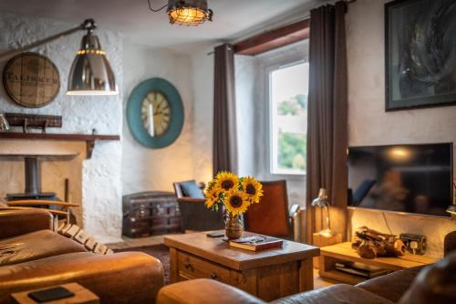 a living room with a vase of sunflowers on a table at The King's Berth in Portree