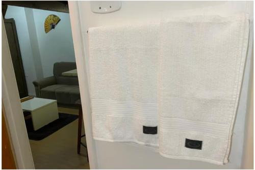 a towel hanging on a door in a living room at Apartamento Centro do Rio de janeiro in Rio de Janeiro