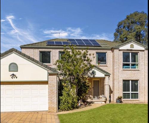 a house with solar panels on the roof at Modern Home - 10 Guests - 5 Bedrooms and Pool in Bundamba