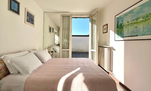 a bedroom with a large bed and a window at Casa Mary Varenna in Varenna
