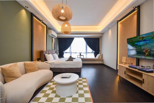 a hotel room with a bed and a tv at R&F Princess Cove by Nest Home at Johor Bahru in Johor Bahru