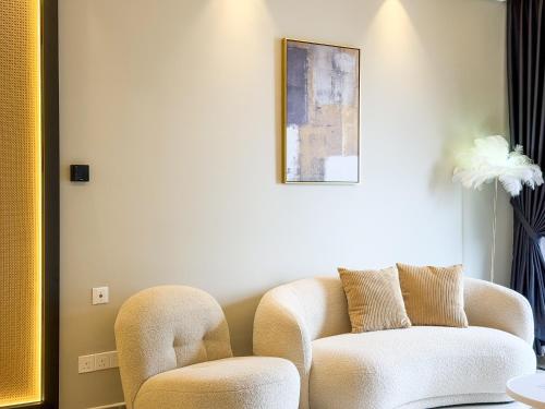a living room with two chairs and a couch at R&F Princess Cove by Nest Home at Johor Bahru in Johor Bahru