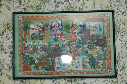 a painting hanging on a wall in a room at Bed and Pillow Hostel in Kathmandu