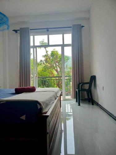 a bedroom with a bed and a large window at Kandy Horizon Homestay in Kandy