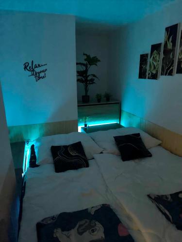 a bedroom with a large bed with blue lights at Welness, Holiday Cheb-Skalka in Cheb