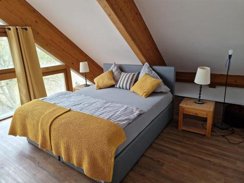 a bedroom with a bed with yellow pillows on it at Ruheoase in Fürstenzell in Fürstenzell