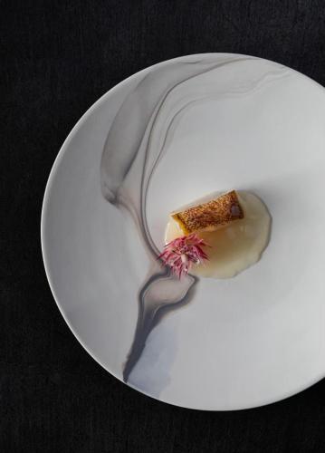 a white plate with a piece of food on it at 時地人 jijijin MATSUYAMA in Tobe