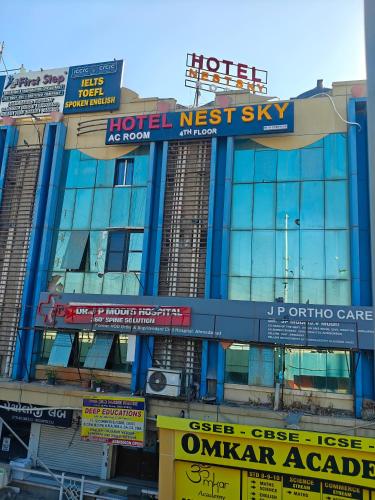 a building with signs on the side of it at Hotel Nest Sky in Ahmedabad
