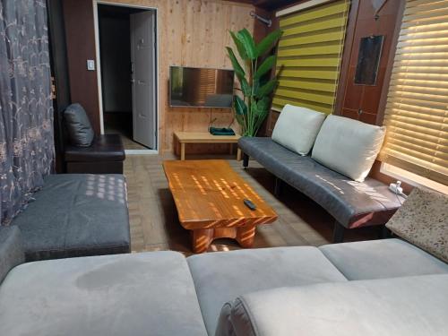 a living room with a couch and a coffee table at Vernia in Yeosu