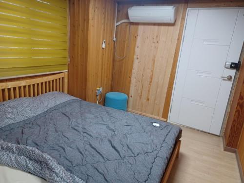 a bedroom with a bed and a shower at Vernia in Yeosu