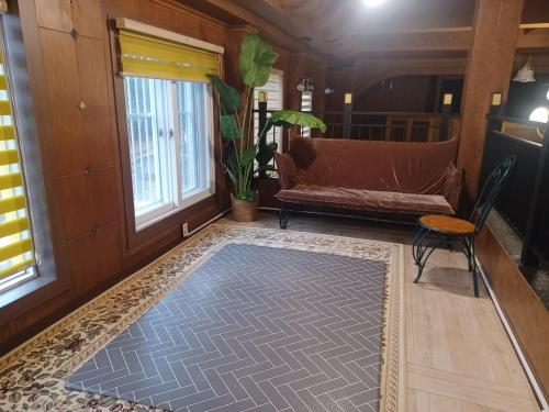 a living room with a couch and a rug at Vernia in Yeosu