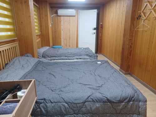 a bedroom with two beds in a room at Vernia in Yeosu