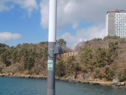 a pole in the water next to a river at Vernia in Yeosu