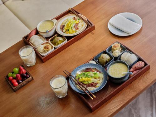 a table with plates of food and bowls of food at Pandora Boutique Hotel---Within Zhangjiajie National Forest Park in Zhangjiajie