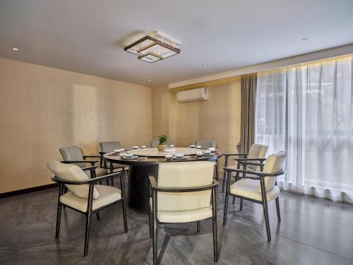 a dining room with a table and chairs at Pandora Boutique Hotel---Within Zhangjiajie National Forest Park in Zhangjiajie