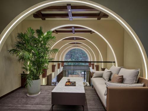 a living room with a couch and a table at Pandora Boutique Hotel---Within Zhangjiajie National Forest Park in Zhangjiajie