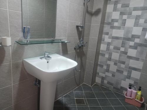 a bathroom with a sink and a shower at Vernia in Yeosu