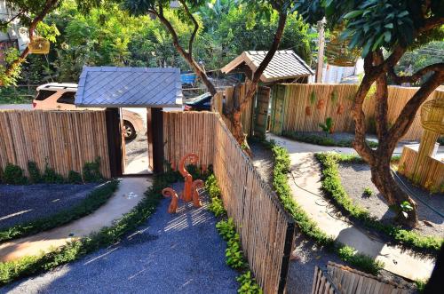 a backyard with a fence with a solar panel on it at Feitsui in Chiang Mai