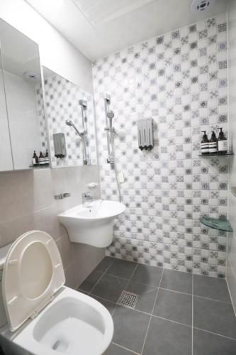 a bathroom with a toilet and a sink at A Bridge House 1-B in Incheon