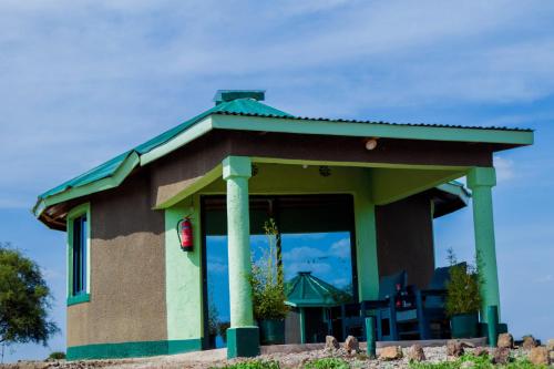 a small house with a green roof at Amboseli Amanya Lodge in Amboseli