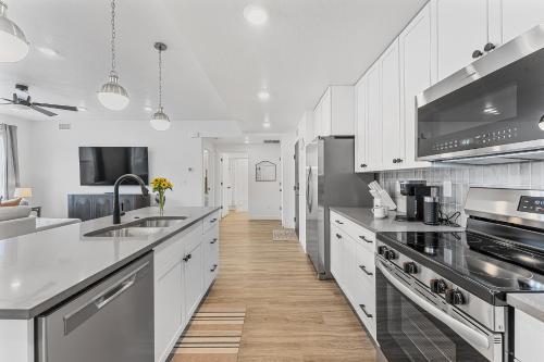 a kitchen with white cabinets and stainless steel appliances at Sky Haven #202 condo in Hurricane
