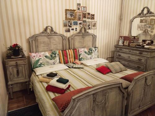 a bedroom with two beds and a dresser at L'angolo in Turin
