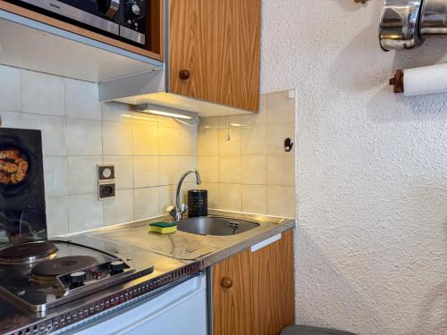 une petite cuisine avec un évier et une cuisinière dans l'établissement Charmant Studio Avec Terrasse By TerraAlpina, à Saint-Gervais-les-Bains