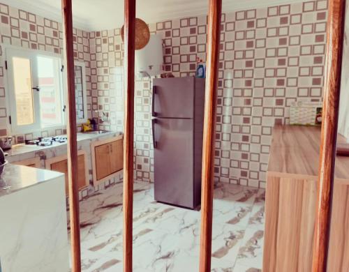 a kitchen with a purple refrigerator in a room at residence Eden Garden 1 in Abidjan