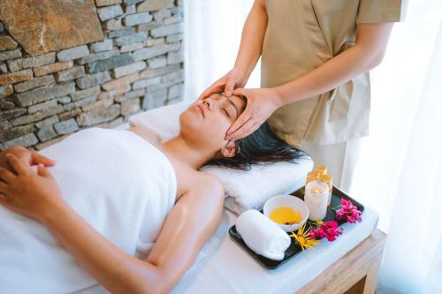 a woman getting a massage from a spa therapist at Organic Village Retreat in Hundar