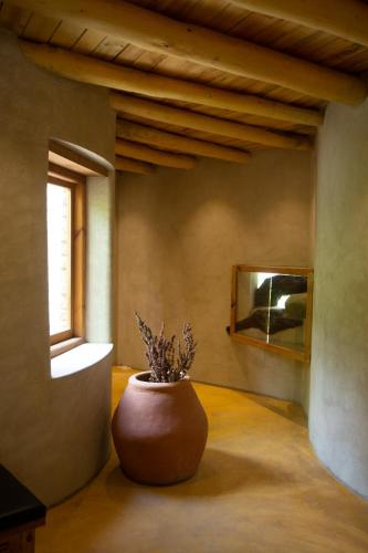 a large vase sitting on the floor in a room at Organic Village Retreat in Hundar