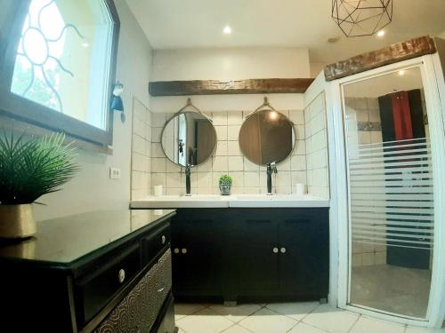 a bathroom with a sink and a mirror at Gers habitation in Montégut