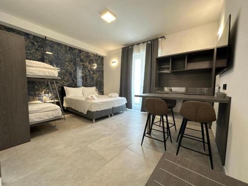 a bedroom with two beds and a desk and chairs at Umberto 28 Guest House in Sassari