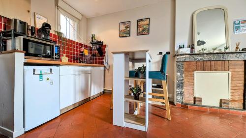 a kitchen with a white refrigerator and a microwave at Maison cosy - Centre - Perche in Tourouvre