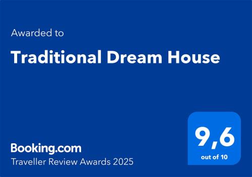 a blue sign with the text translated to traditional dream house at Traditional Dream House in Soroni