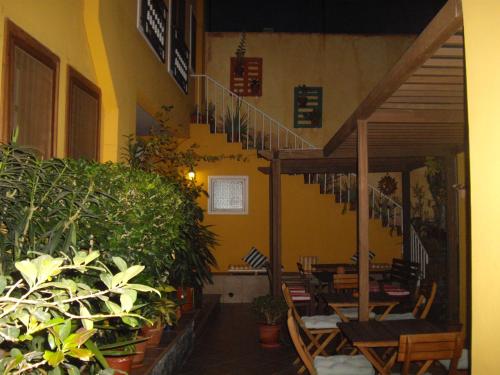 a restaurant with tables and chairs and potted plants at Kira's Boutique Hotel in Mindelo