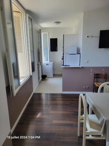 a room with a kitchen with a table and a kitchen at grand T4 proche sanctuaires in Lourdes