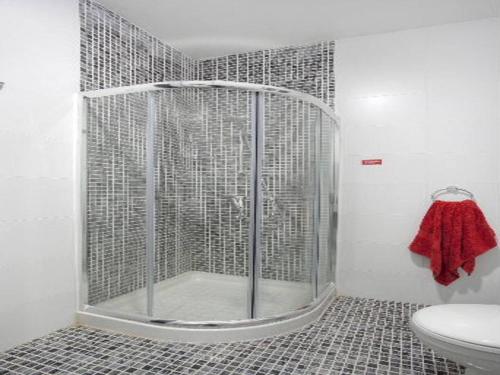 a shower stall in a bathroom with a toilet at Villa Sunnyside in St Julian's