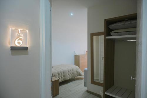 a room with a mirror and a bed in a bedroom at B&B Diana in Piazza Armerina