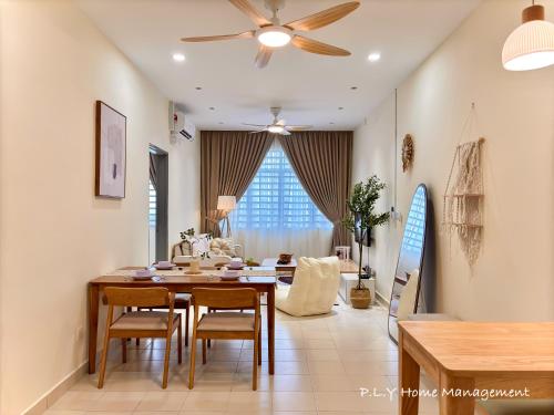 a living room with a dining table and a ceiling fan at Muji Ipoh Falim Free Parking & Free Netflix in Ipoh