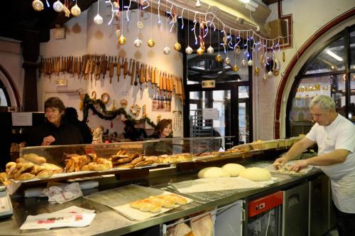 a man standing in a kitchen preparing food at Gite See You Soon - Studio Pep's in Sélestat