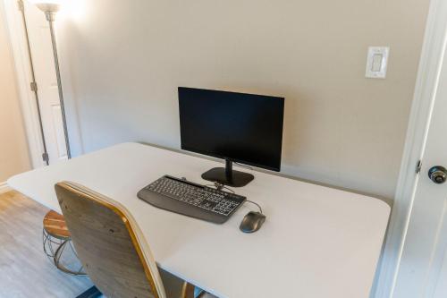 a desk with a computer monitor and a keyboard and mouse at LUX Retreat - Best Views - All Amenities - Central in Lomita