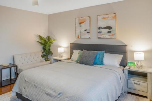 a bedroom with a large bed with two tables and two lamps at LUX Retreat - Best Views - All Amenities - Central in Lomita