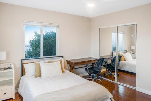 a bedroom with a bed and a desk and a mirror at LUX Retreat - Best Views - All Amenities - Central in Lomita
