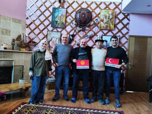 a group of men holding up signs in a room at Tagaytay Karakol Hotel in Karakol