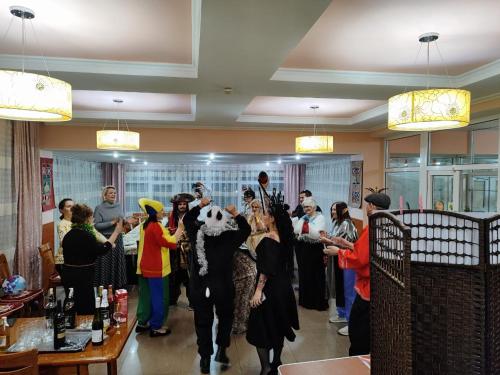 a group of people standing in a barber shop at Tagaytay Karakol Hotel in Karakol