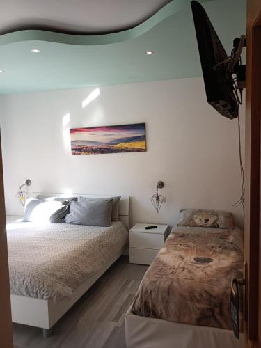 a bedroom with a bed and a painting on the wall at Central Greenlife in Tarvisio