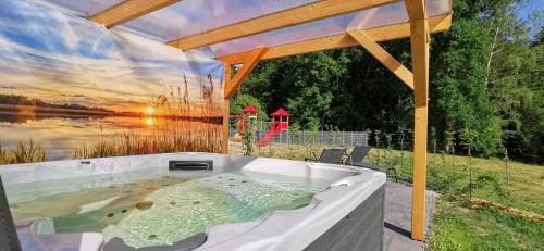 a jacuzzi tub with a view of a lake at Haus Christina Pool Sauna in Malchow