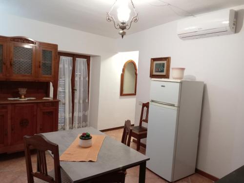 a kitchen with a table and a refrigerator at Casa VACANZE LUSITANA C2 in Foligno